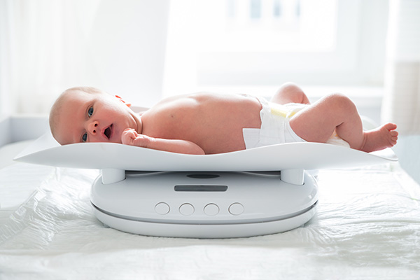 picture of a baby being weighed